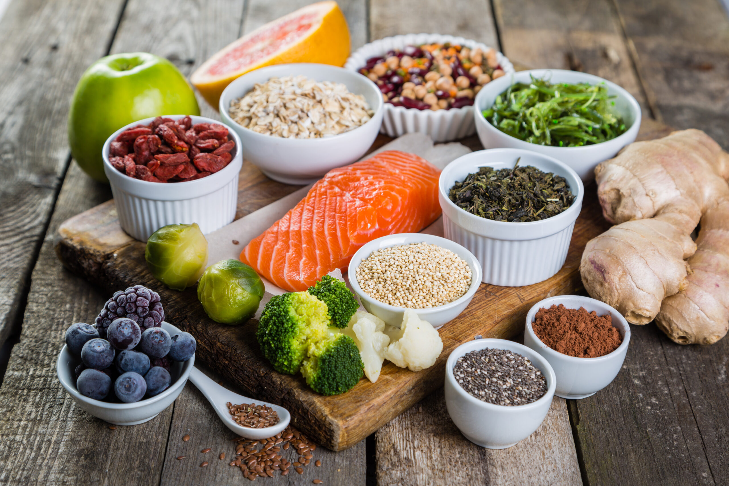 Selection of superfoods on rustic background