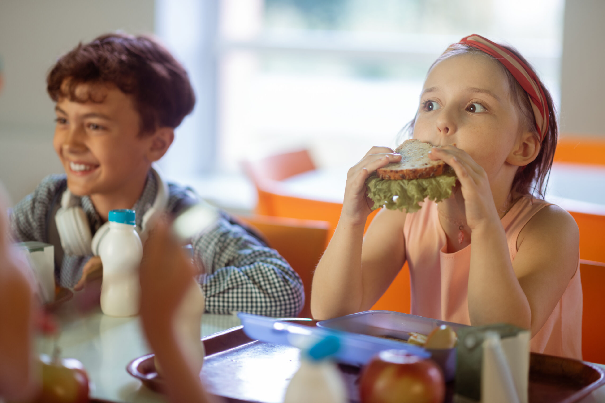 Girl eating sandwich during school lunch